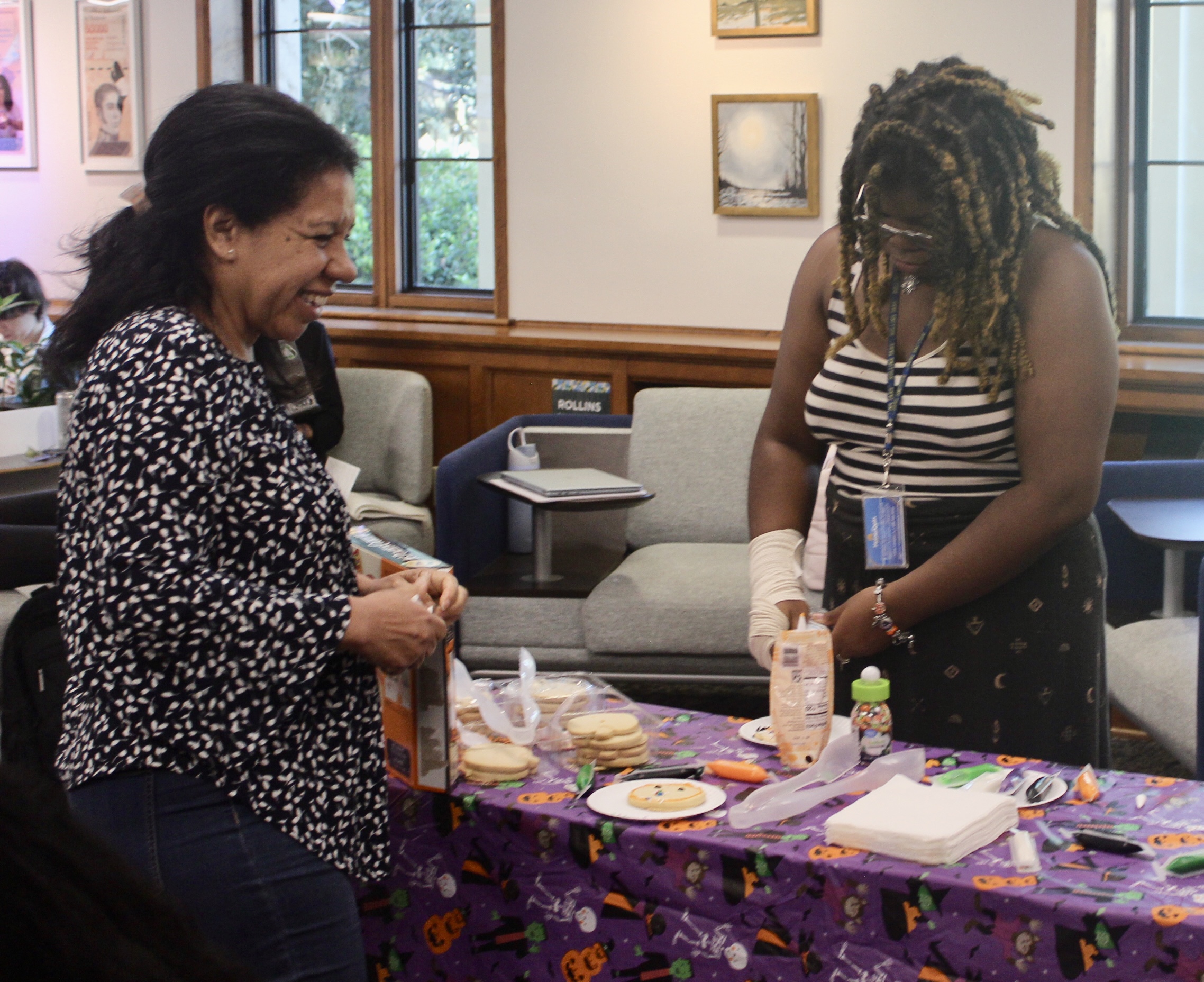 Rollins students decorate cookies at Olin Halloween event